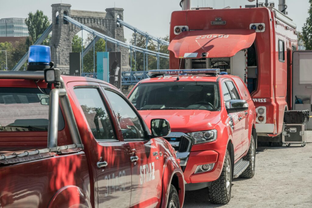 Fire service vehicles parked near a bridge in Wrocław, showcasing an emergency response scene.